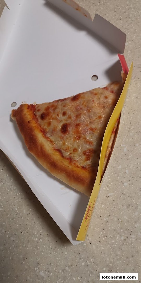 A slice of cheese pizza in a white takeout box with a yellow insert.