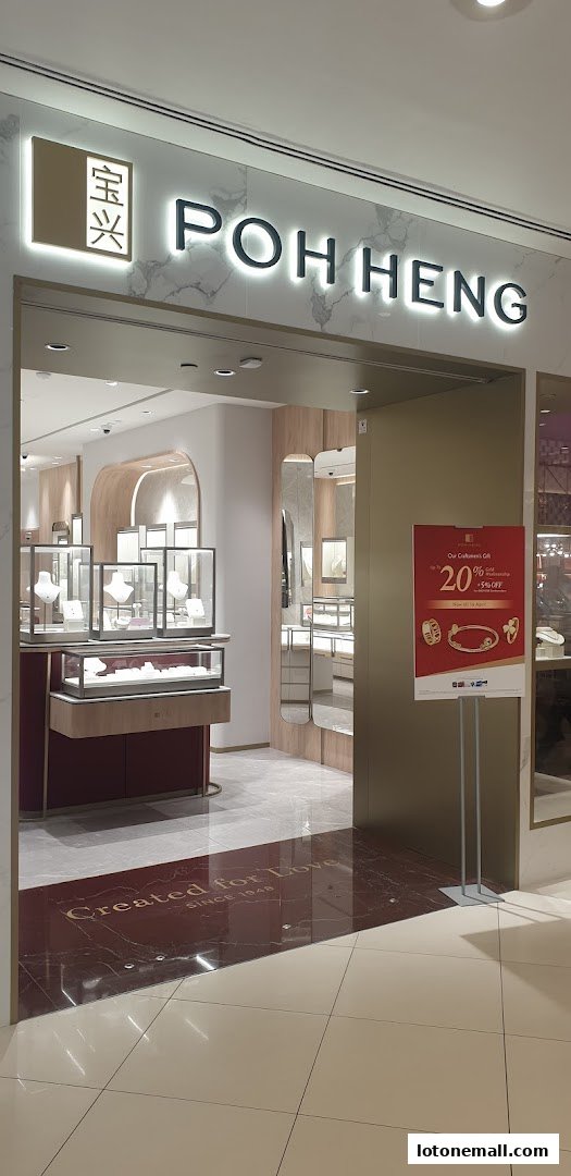 The entrance of Poh Heng Jewellery, showcasing elegant displays and a promotional sign.