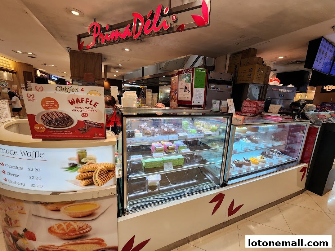 A display of cakes and waffles at a PrimaDéli bakery.