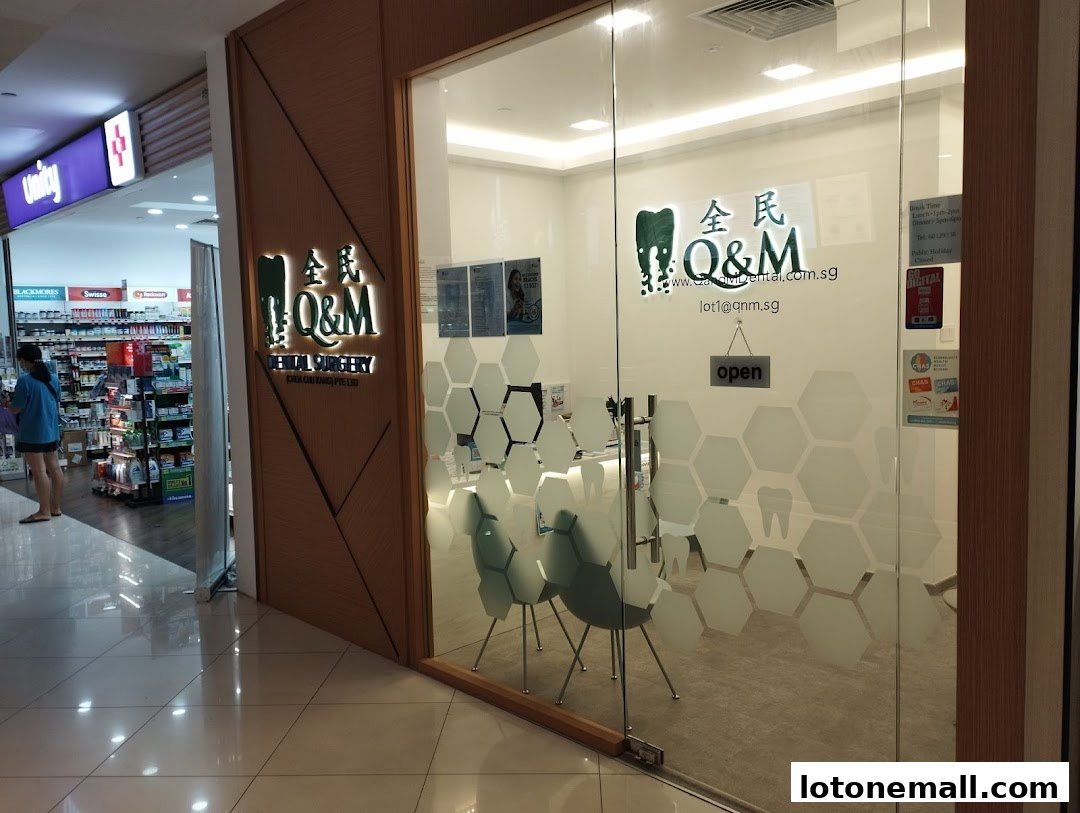 The entrance to Q&M Dental Surgery at Lot One Shopping Mall, with a clean and modern interior visible.