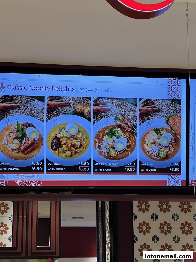 A digital menu board displaying classic noodle dishes with prices and images.
