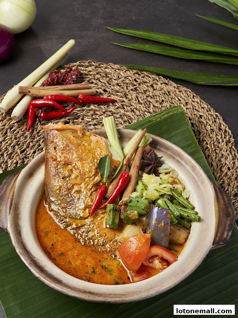 A close-up of a flavorful fish head curry with vegetables and spices.