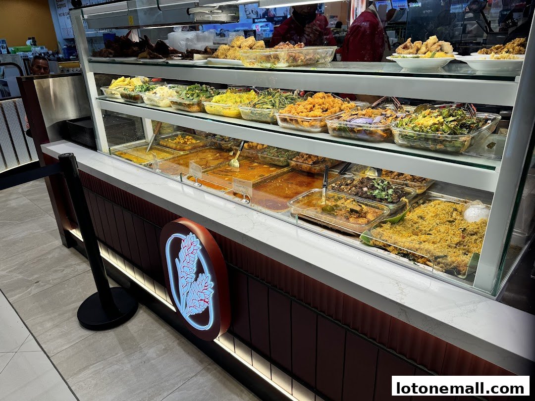 A display case filled with various prepared dishes, including rice, curries, and vegetables.
