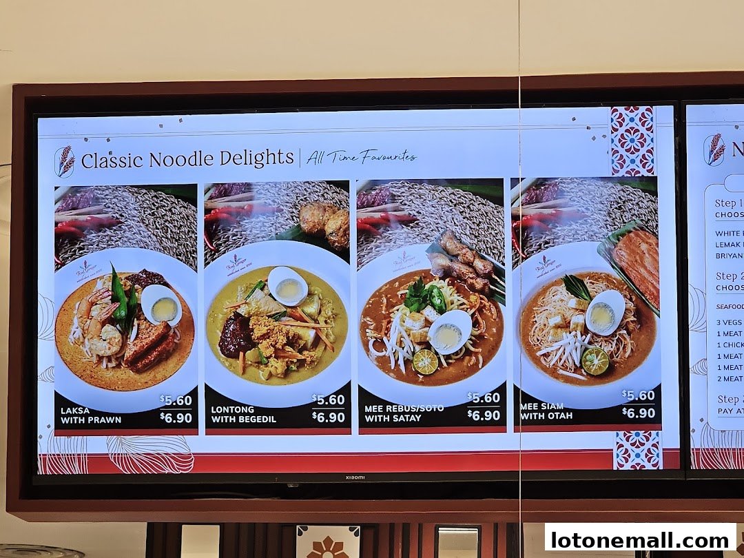 A digital menu board displaying classic noodle dishes with prices.