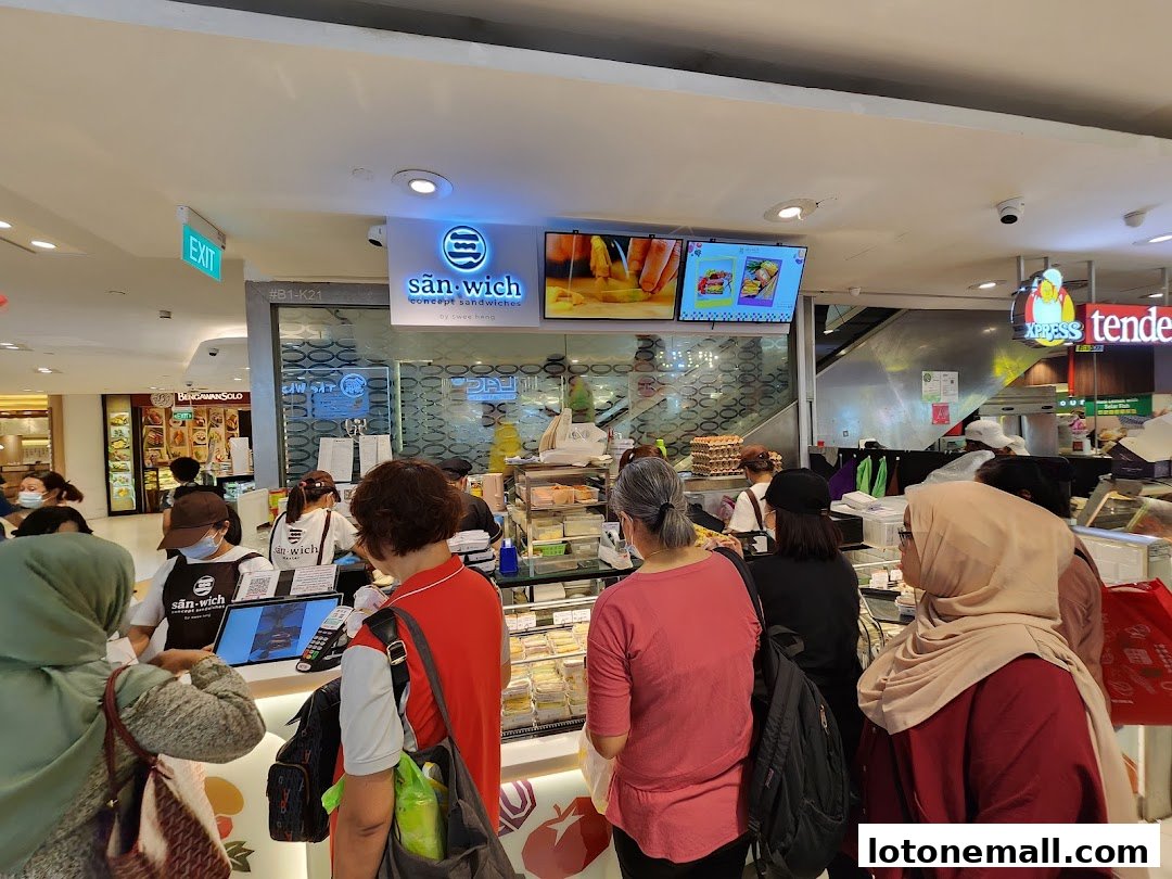 Customers queue at San.wich by Swee Heng, a sandwich shop with a bright display.