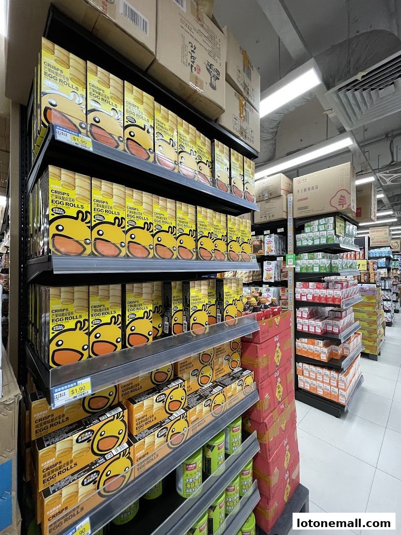 Shelves stocked with boxes of egg rolls featuring a cartoon duck design in a supermarket.