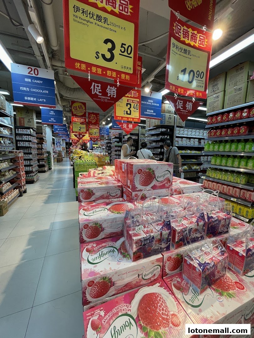 A supermarket aisle with promotional displays of strawberry-flavored drinks and other products.