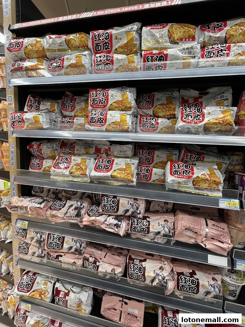 Shelves stocked with packaged food items, primarily noodles, in a supermarket.