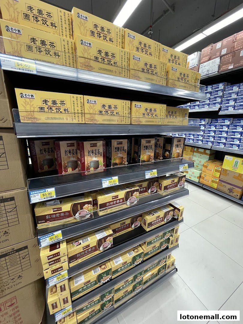Shelves stocked with boxes of ginger tea and other beverages in a supermarket.