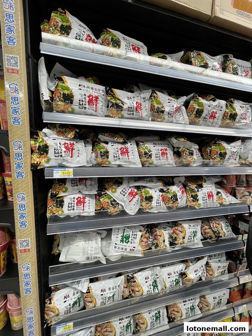 Shelves stocked with packaged food items, likely Asian cuisine, at Scarlett Supermarket.