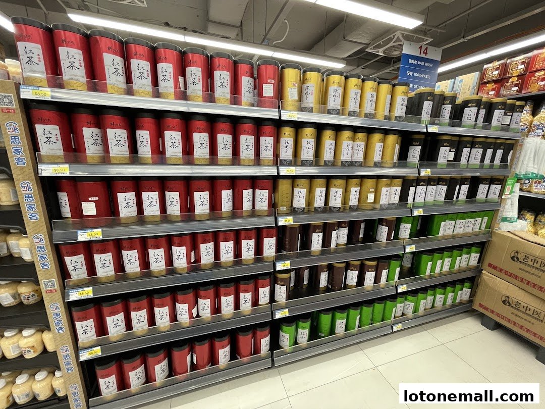 Shelves stocked with various tea products in red and yellow packaging.