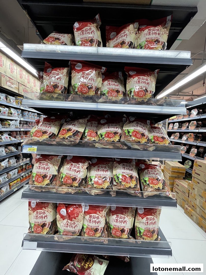 Shelves stocked with packaged food items, featuring prominent red and white packaging.
