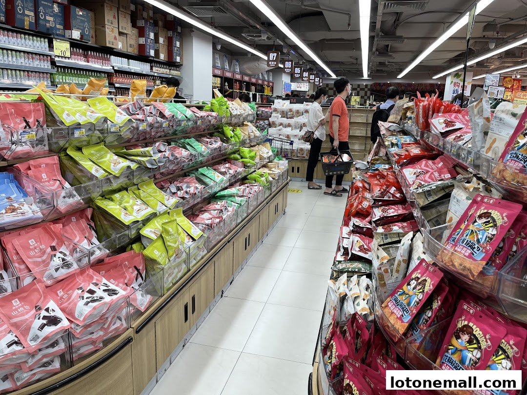 A wide aisle in a supermarket filled with various snacks and food products on display.