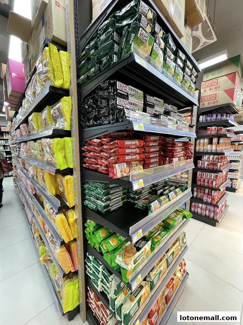 Shelves stocked with various snacks and packaged goods in a supermarket.