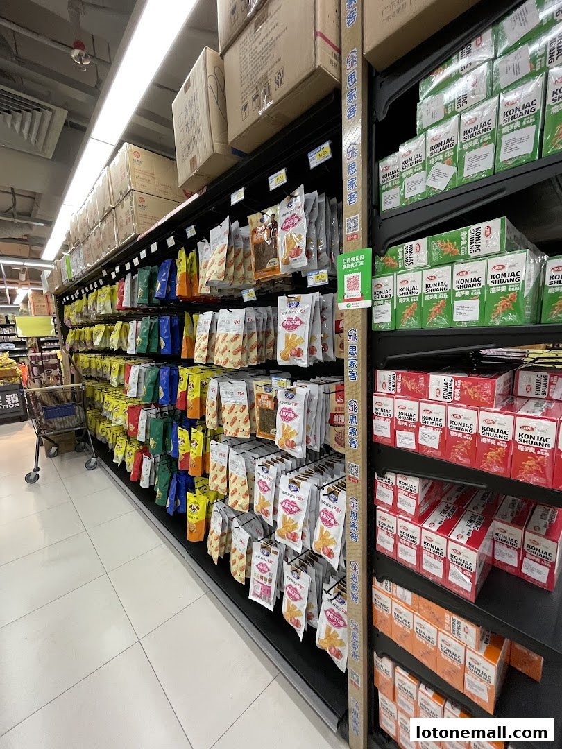 A supermarket aisle stocked with various packaged snacks and konjac products.
