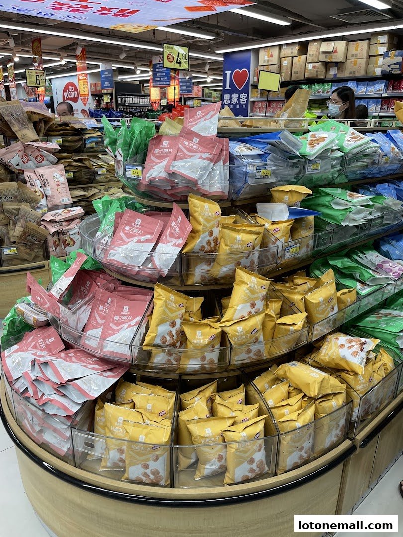 A supermarket aisle displaying various packaged snacks and food items on shelves and a circular display.