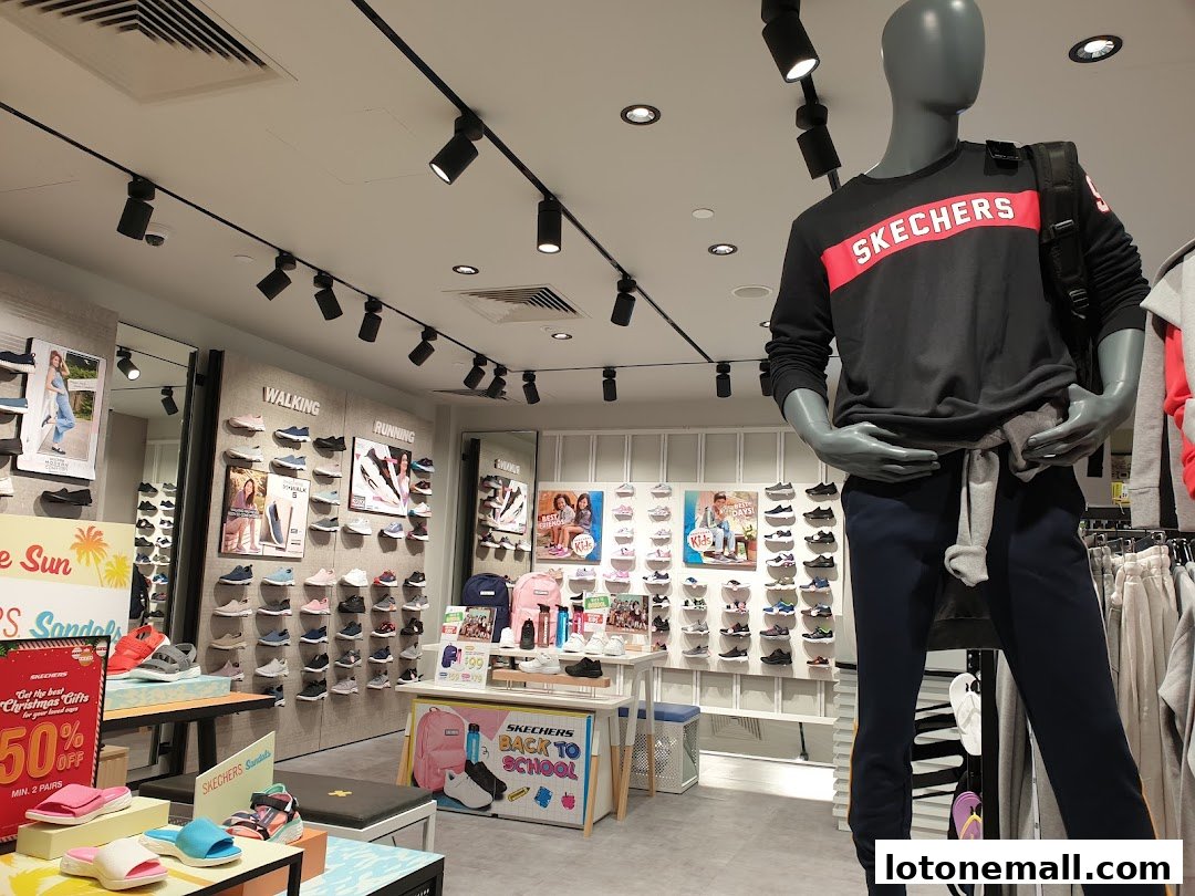 Interior of a Skechers store showcasing shoes, apparel, and a mannequin.