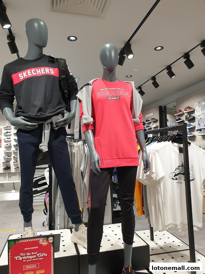 Mannequins display Skechers apparel, including sweatshirts and pants, with shoes visible in the background.