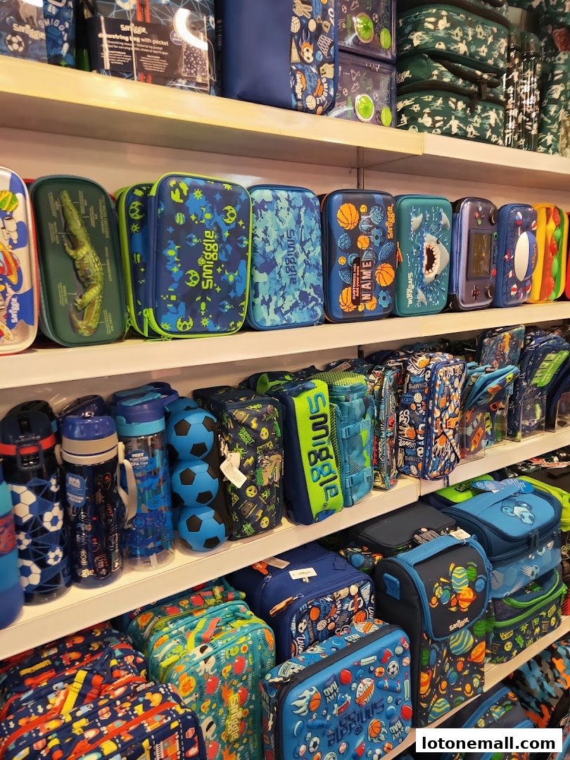 Shelves filled with colorful Smiggle stationery, bags, and lunchboxes featuring playful designs.