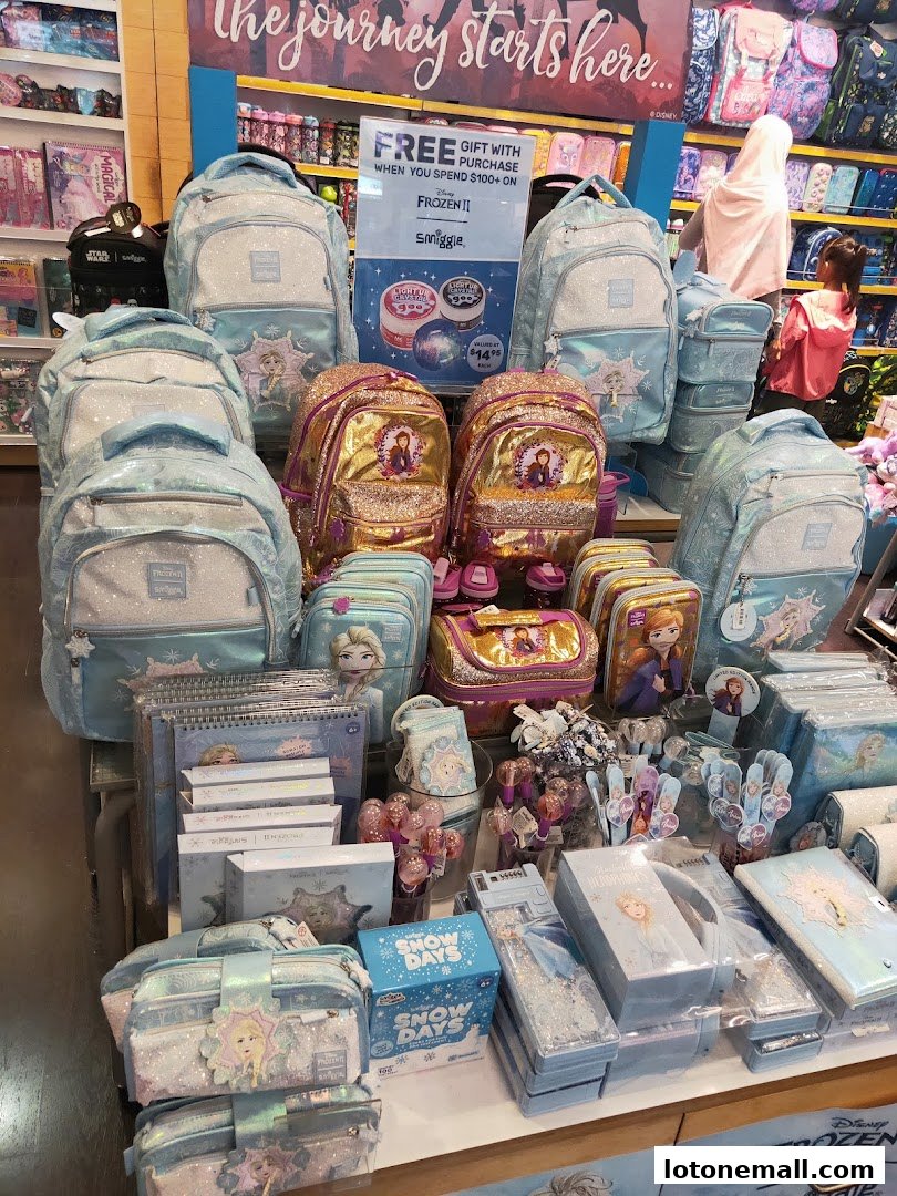 Smiggle store display featuring Frozen II themed backpacks, pencil cases, and stationery.