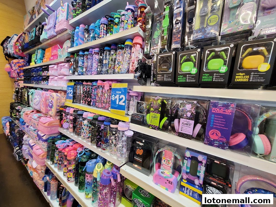 Shelves stocked with colorful backpacks, lunchboxes, water bottles, headphones, and tech accessories.