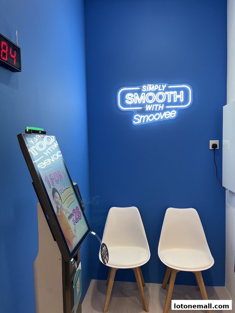 Interior of Smoovee Skin Korean Hair Removal with neon sign, digital display, and chairs.