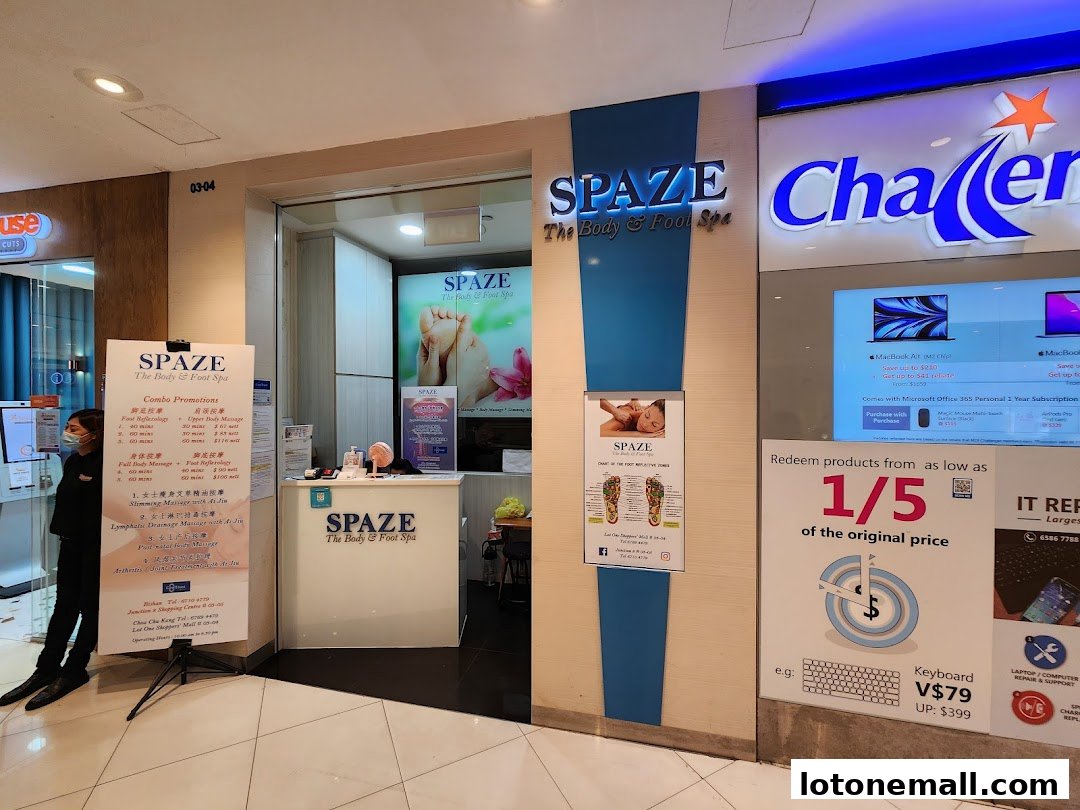 The entrance of SPAZE The Body & Foot Spa, with promotional posters and a reception desk visible.