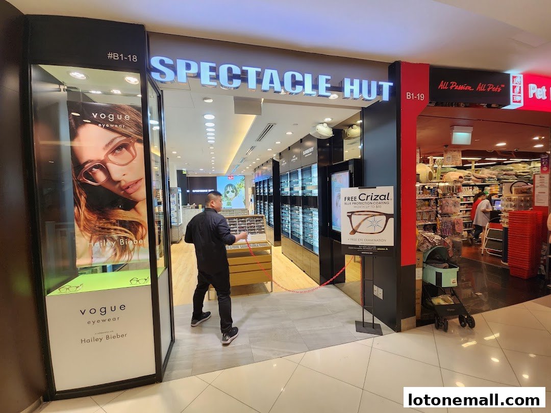 Spectacle Hut shop front with displays of eyewear and a Vogue Eyewear advertisement.