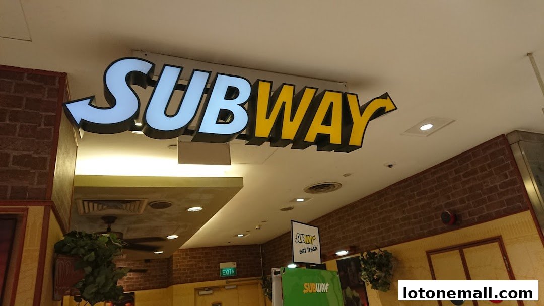 The Subway logo is prominently displayed on the ceiling of a mall.