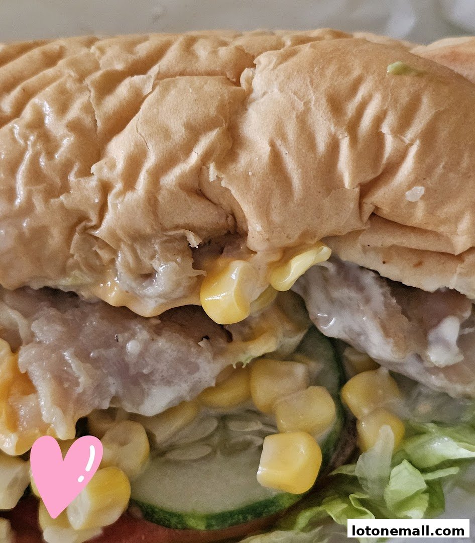 A close-up shot of a delicious Subway sandwich with corn, chicken, and fresh vegetables.
