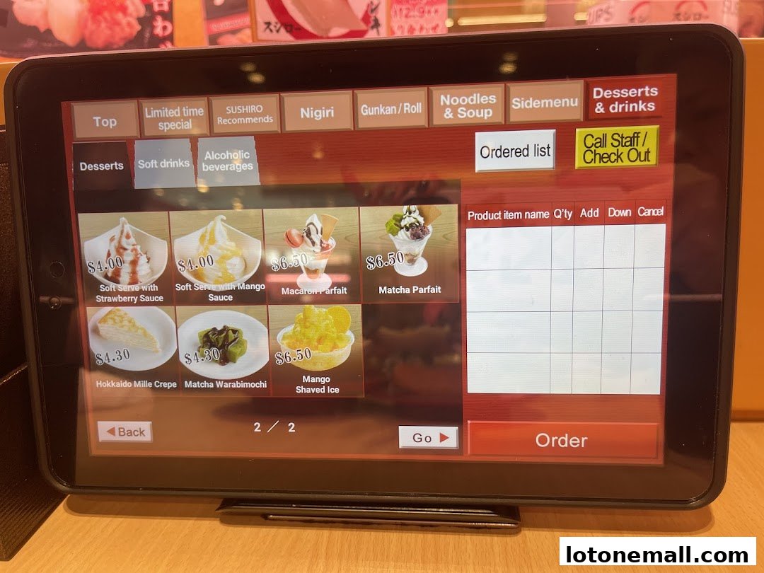 A tablet screen displaying a dessert menu with prices and images.