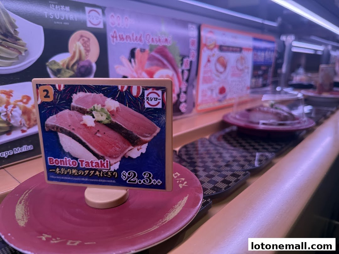 A plate of Bonito Tataki sushi on a conveyor belt at Sushiro.
