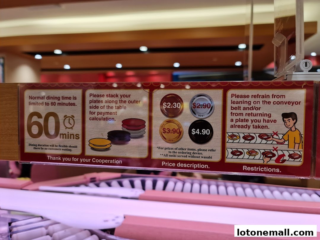 Signage at Sushiro Lot One detailing dining time, plate stacking, pricing, and restrictions.