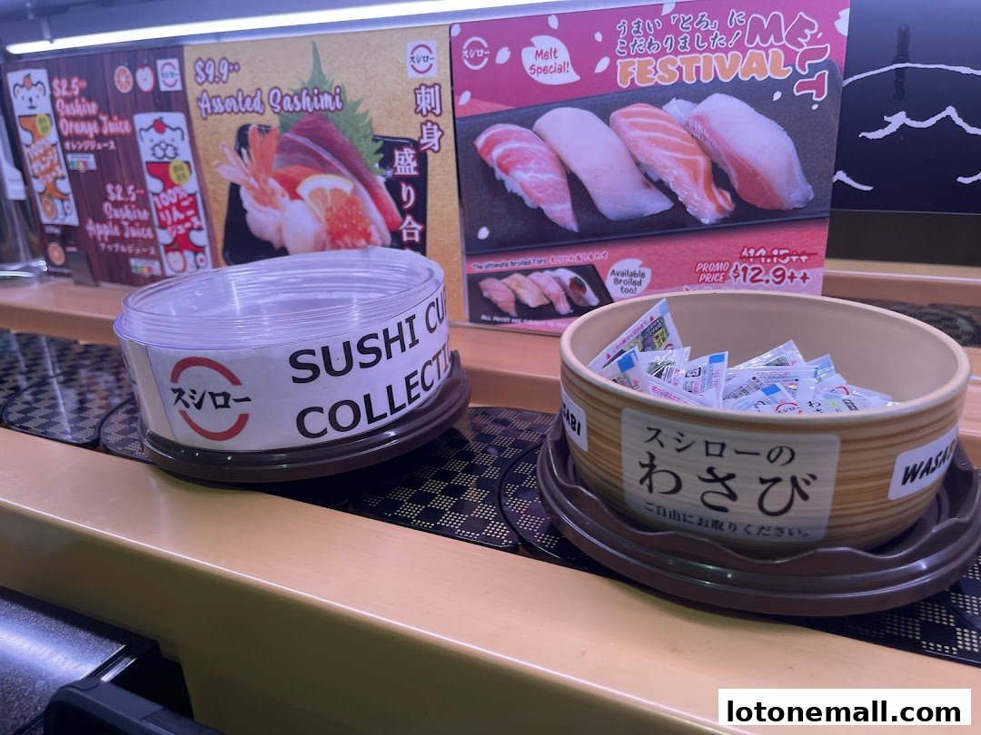A conveyor belt sushi restaurant display with sushi and sashimi promotions, and condiment containers.
