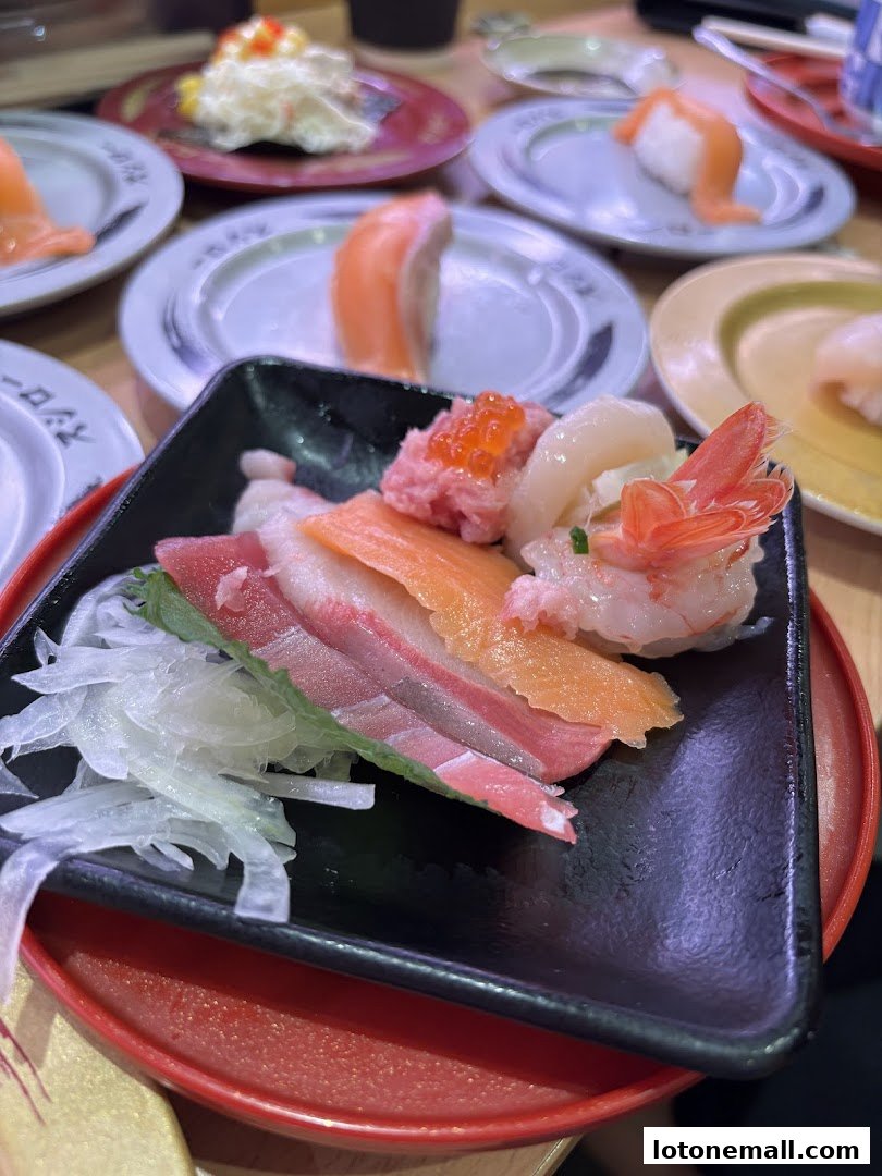 A close-up of a plate of assorted sushi with various types of fish and shrimp.