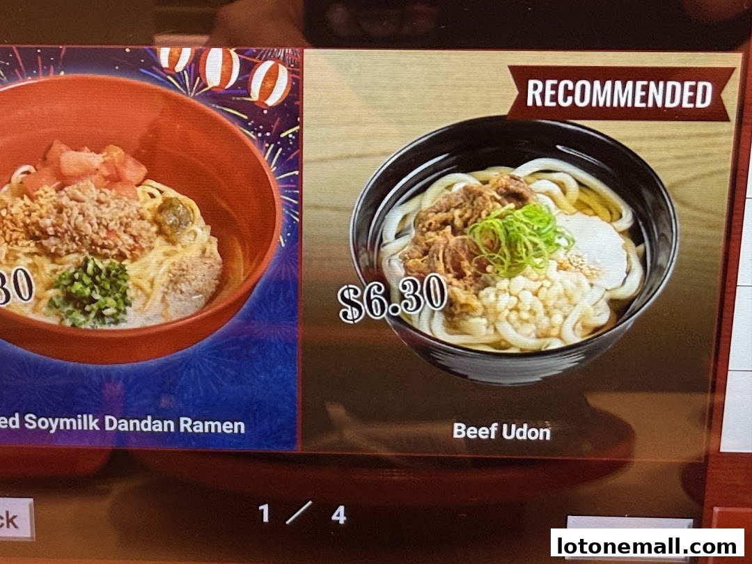 A close-up of two Japanese noodle dishes, one recommended, displayed on a digital menu.