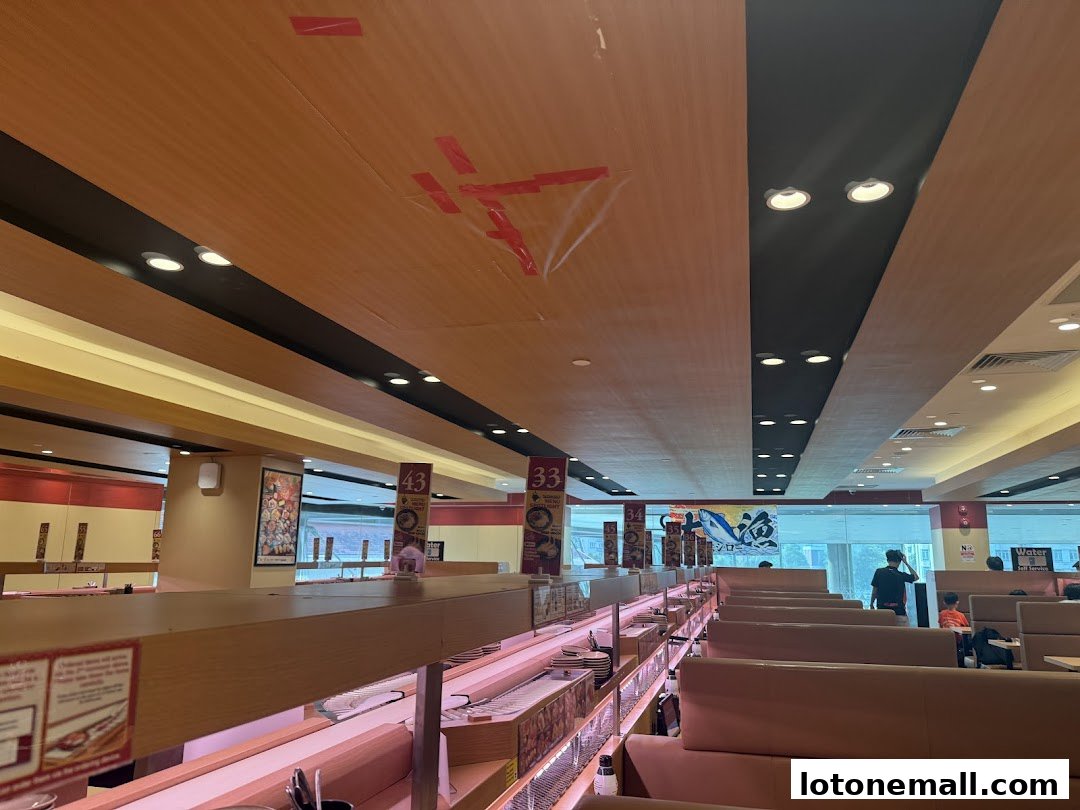 Interior view of a Sushiro restaurant with conveyor belts and seating.