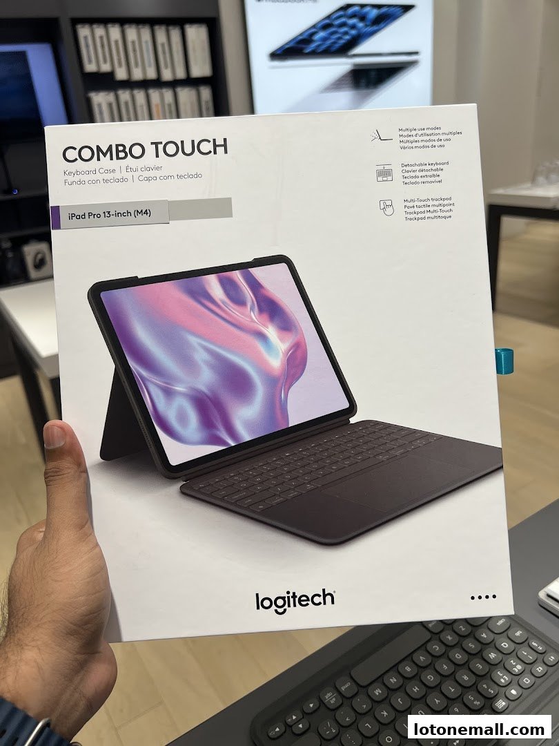 A person holds a Logitech Combo Touch keyboard case for an iPad Pro.