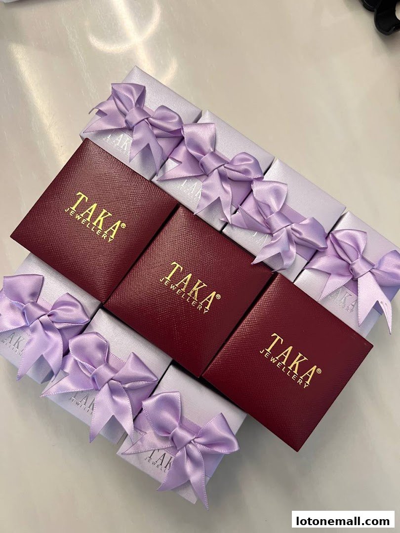 TAKA Jewellery gift boxes and pouches with purple ribbons.