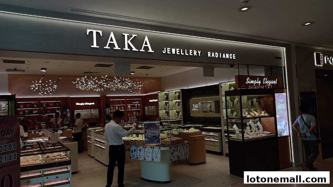 The entrance of TAKA Jewellery Radiance, showcasing elegant displays of jewelry and a grand opening sign.