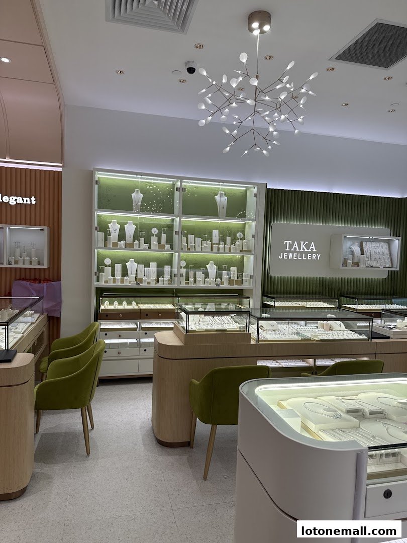 Interior view of a modern jewelry store with display cases and seating.