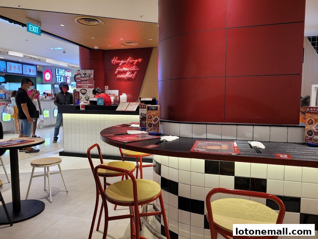 Interior of TamJai SamGor Mixian with customers at the counter and seating area.