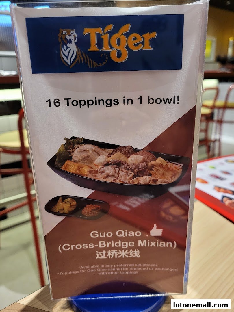 A sign advertising '16 Toppings in 1 bowl!' of Guo Qiao Mixian.