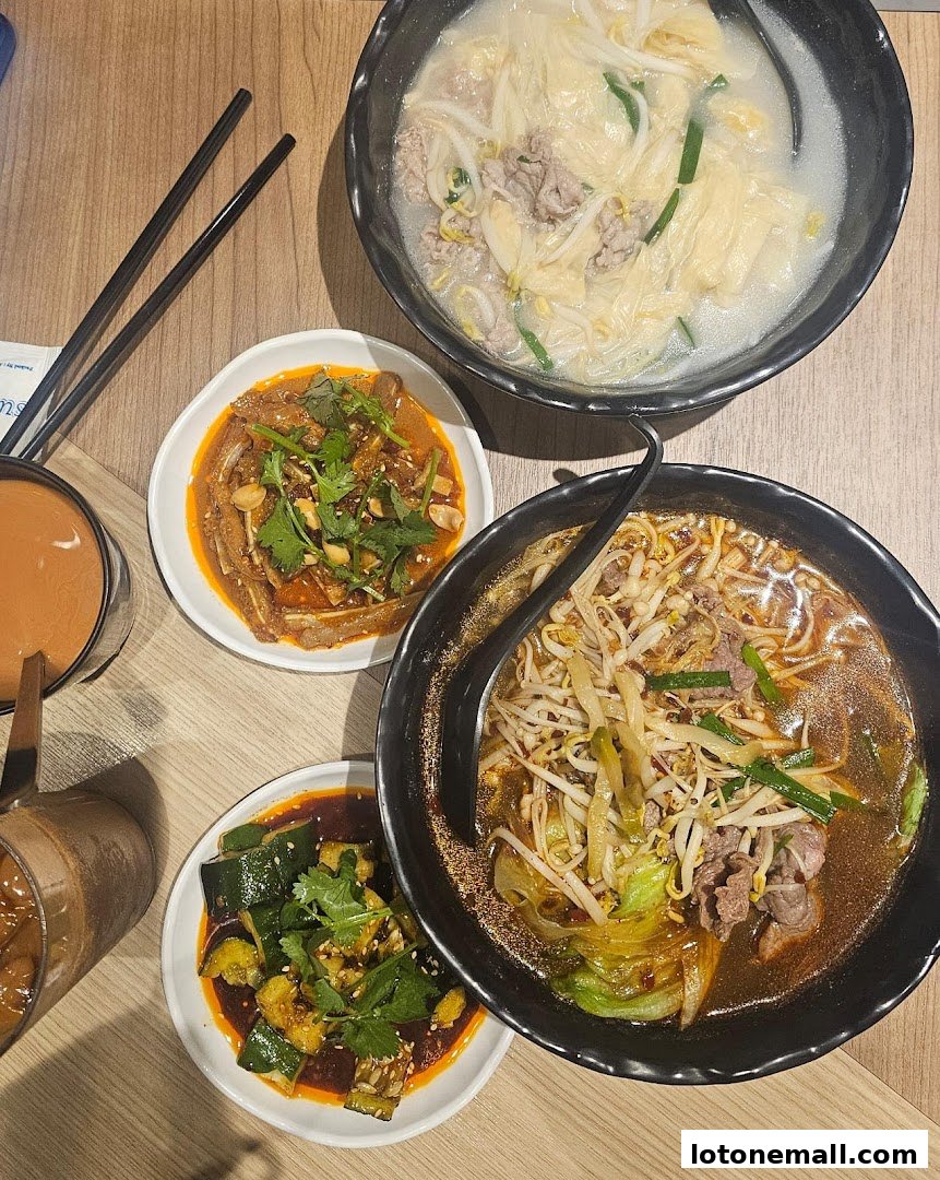A top-down view of a table laden with delicious noodle soups and side dishes.