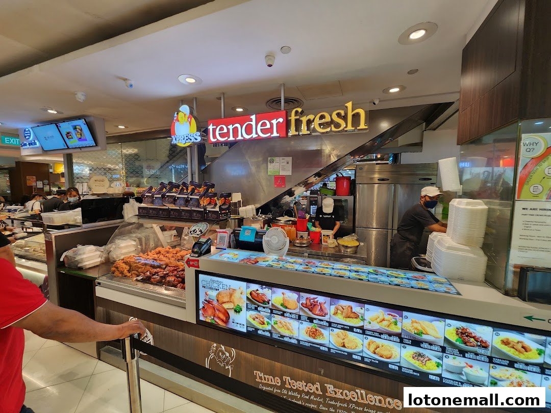 A Tenderfresh Xpress food stall with a display of fried chicken and menu items.
