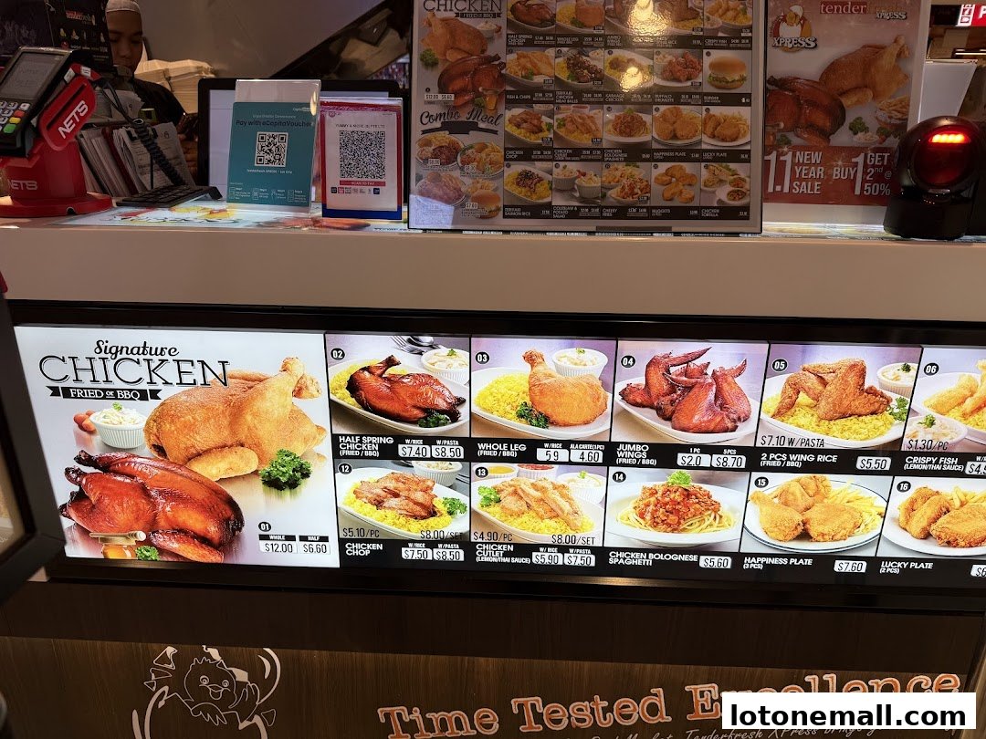 A brightly lit menu display showcasing various chicken dishes and sides at Tenderfresh Xpress.