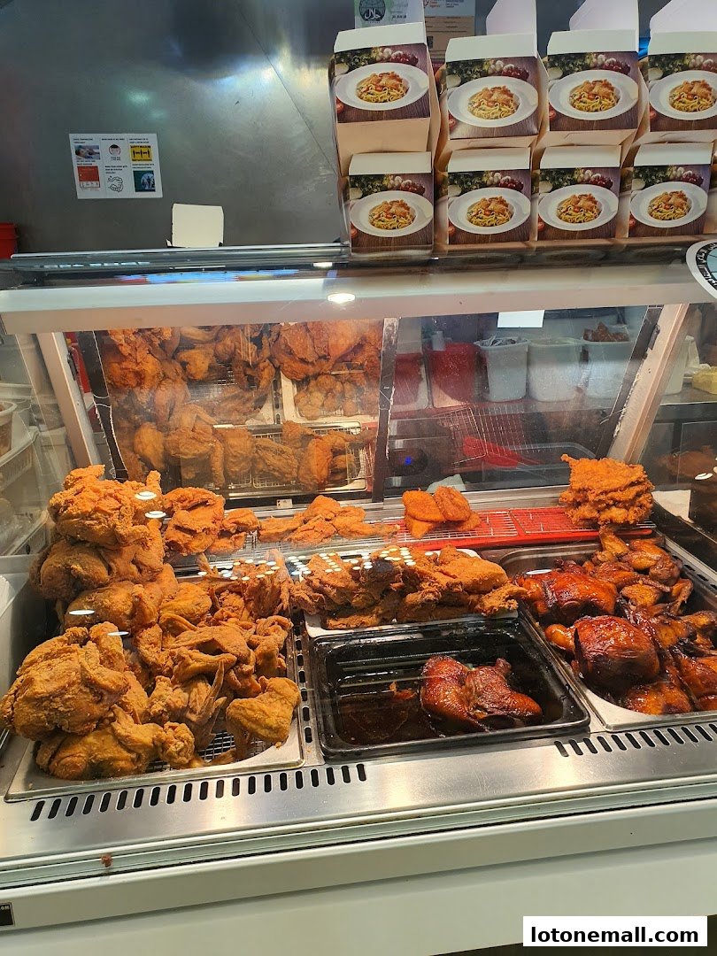 A display case filled with various types of fried and roasted chicken.
