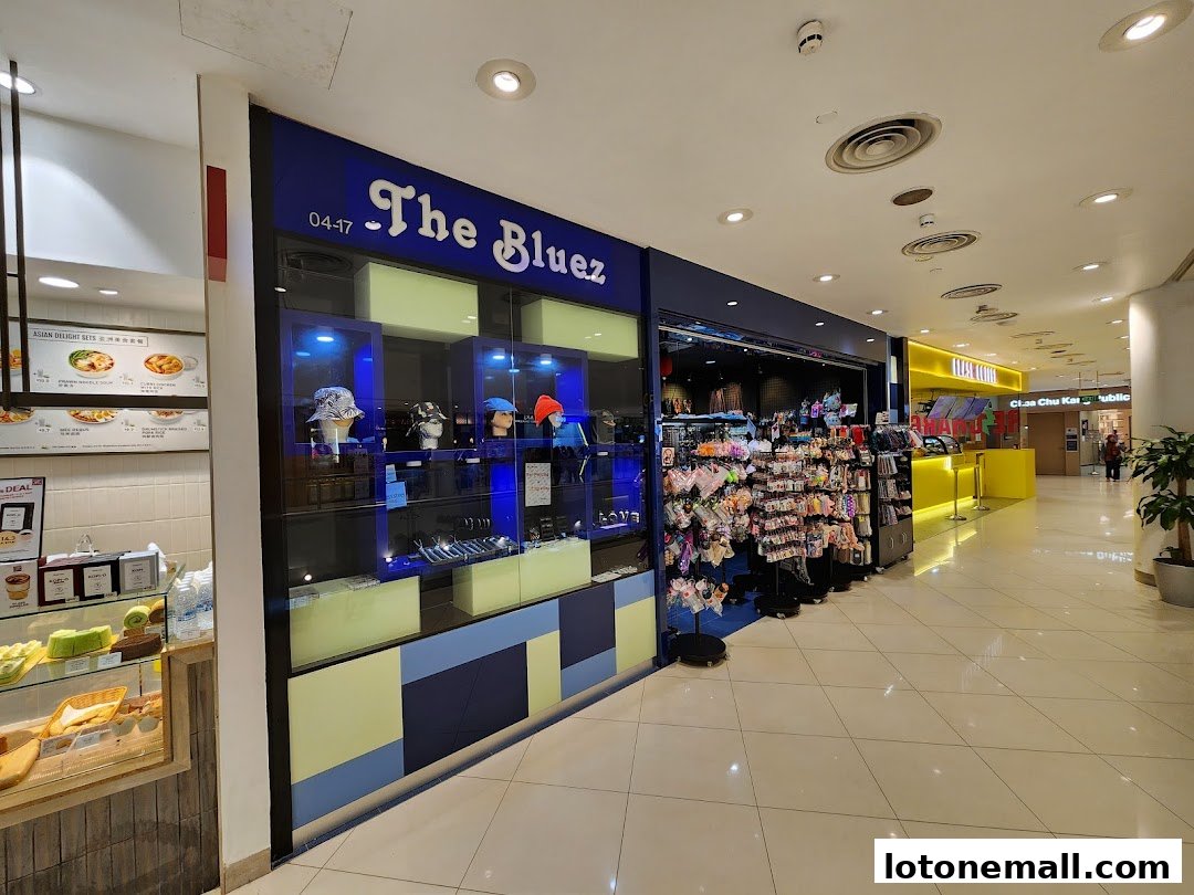 The Bluez shop front displays hats and accessories in a well-lit mall aisle.