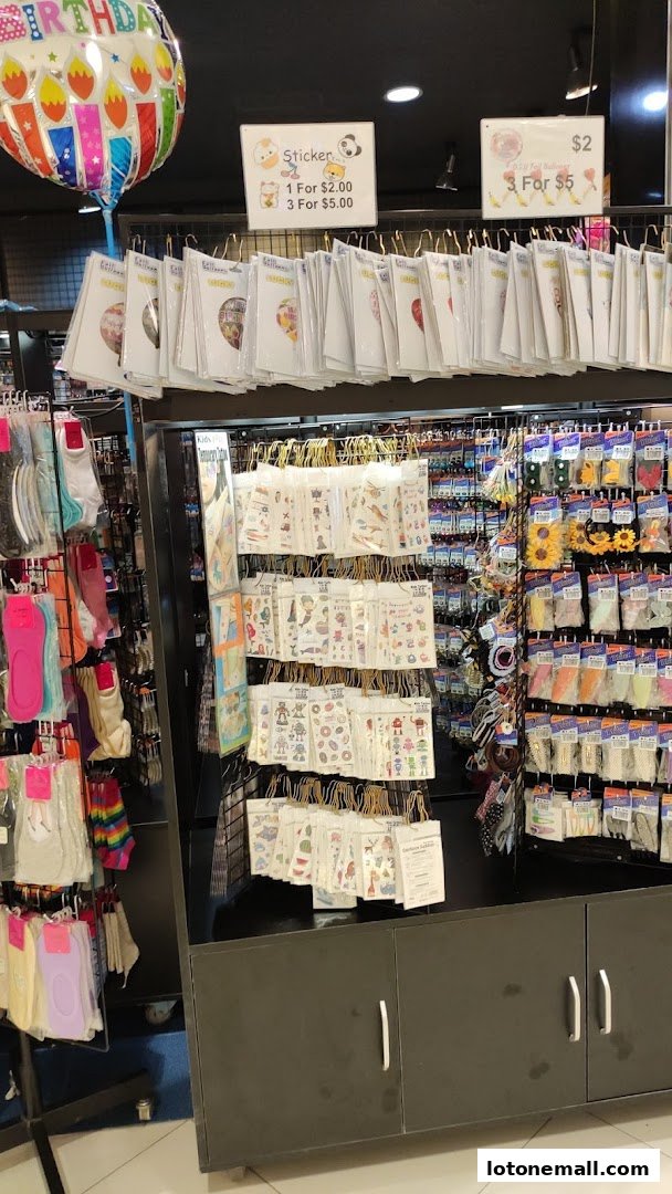 A display of stickers, socks, and party balloons in a retail store.