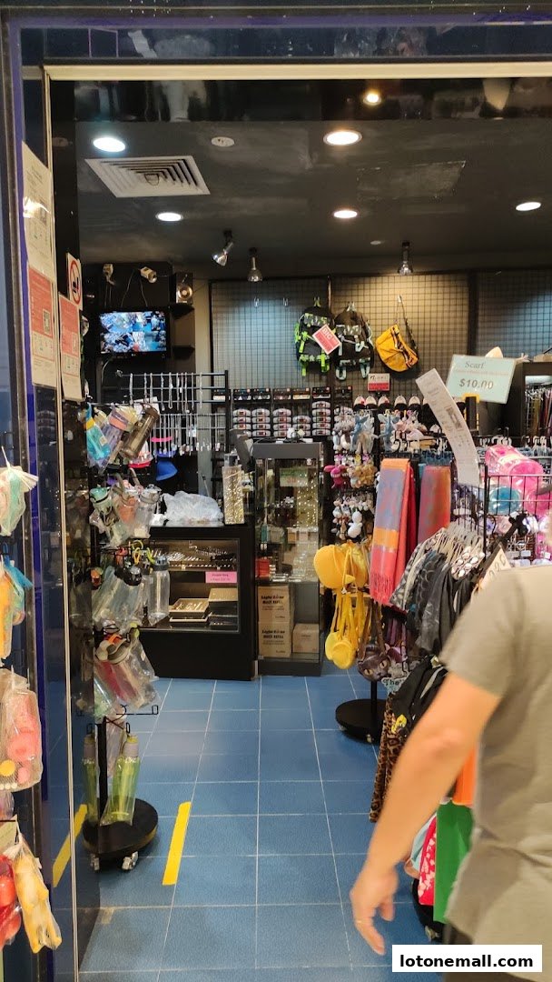 Entrance to a shop displaying various accessories like scarves, bags, and jewelry.